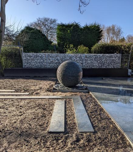 1m Grey Watersphere™ with loose slate chipping beneath. Set in a brand new garden where the patio will meet the grassed area.