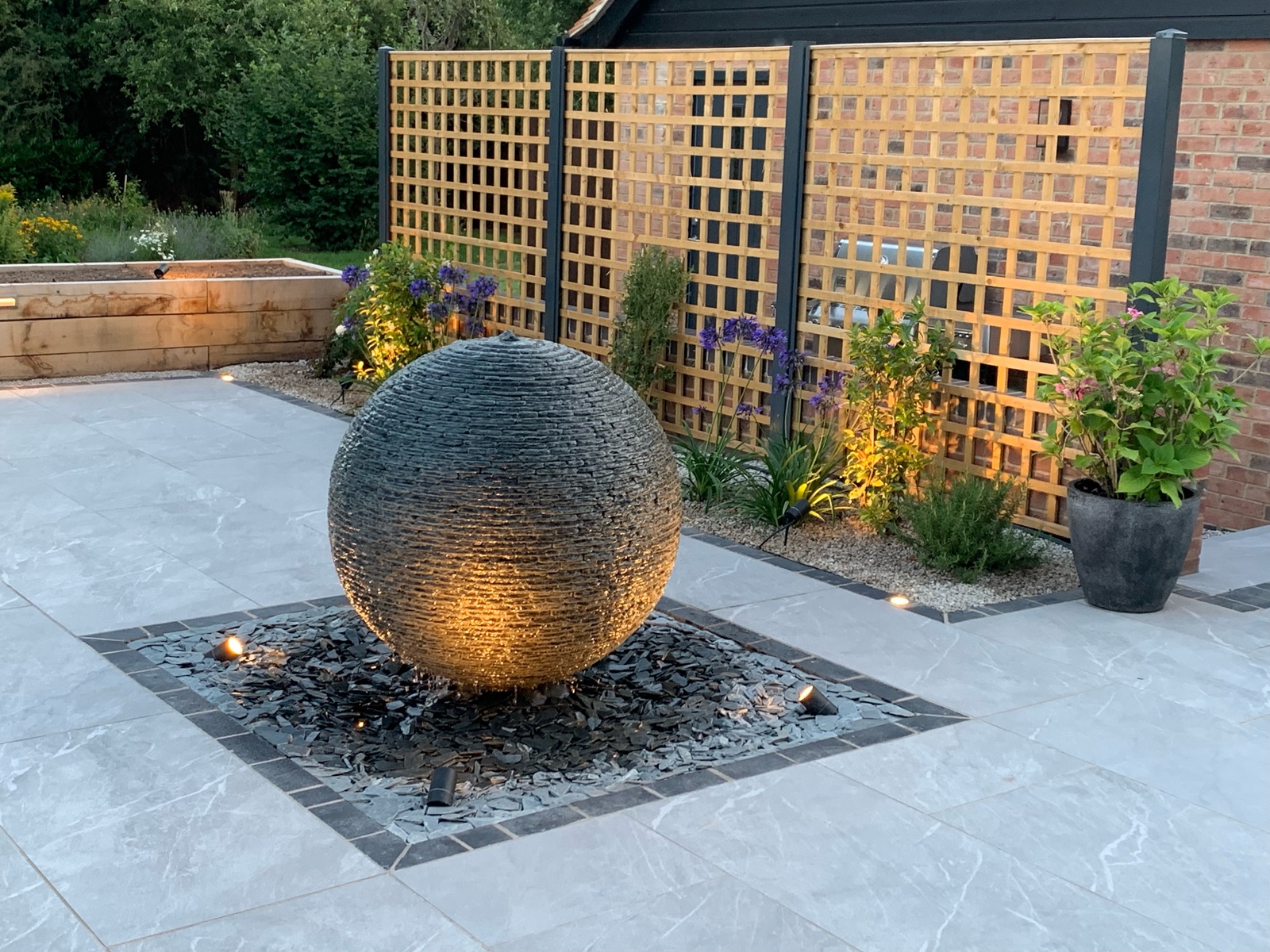 1m Grey Watersphere™ beautifully lit as the summer sun begins to fade. Worchestershire.