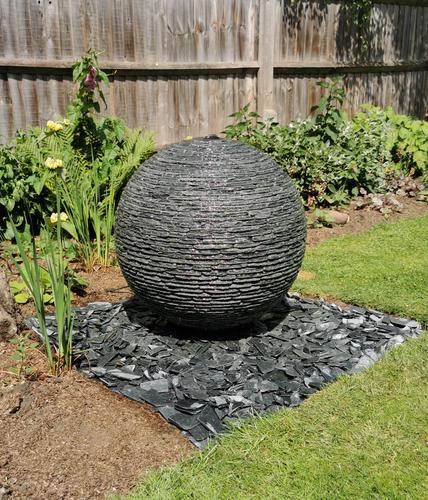 650mm Grey 500mm Grey Watersphere™ on a square bed of matching loose slate chippings, Leicestershire.