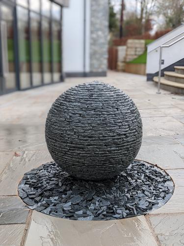 650mm (small) Grey slate Watersphere™ set on a circular bed of slate chippings in the front entrance at Breedon Priory Spa.
