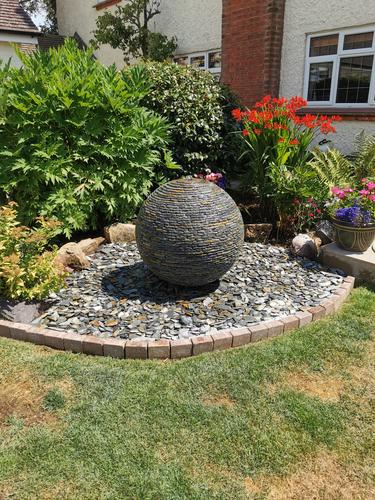 800mm Rustic Watersphere™ set upon a large oval bed of matching loose slate chippings, Colchester.