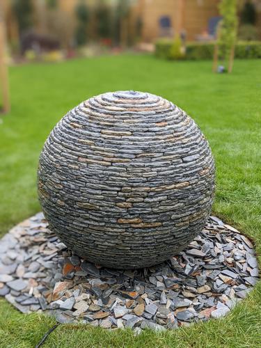 800mm Rustic Watersphere™ set upon a round bed of matching loose slate chippings, cut into the customers lawn.