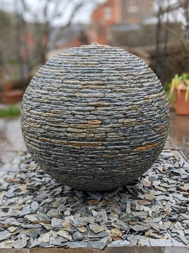 800mm Rustic Watersphere™ set upon a square bed of loose slate chippings, Tiverton.