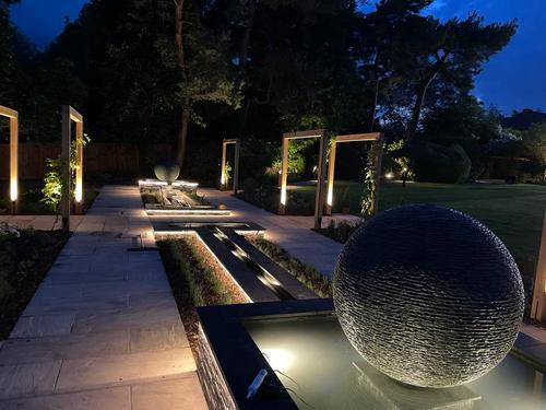 Jeremy Hastings 1.2m extra large grey slate ball water feature on a slate edged pool leading into a rill