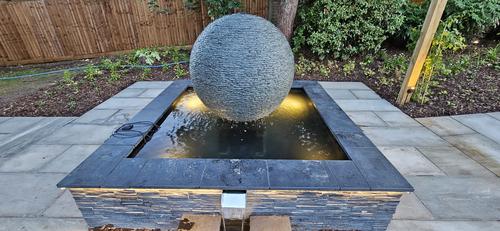 Jeremy Hastings 1.2m extra large grey slate ball water feature, on a slate topped pool