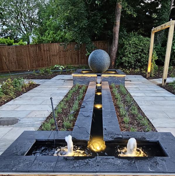 Jeremy Hastings 1.2m grey slate ball water feature on a pool