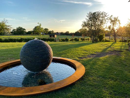 Jeremy Hastings 1.2m rustic Cornish slate ball water feature on a  Corten Steel Pond