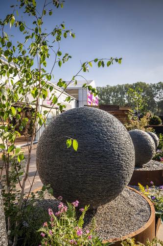 Jeremy Hastings 1.5m XX Large rustic slate ball water feature, on a corten steel base with granite chippings