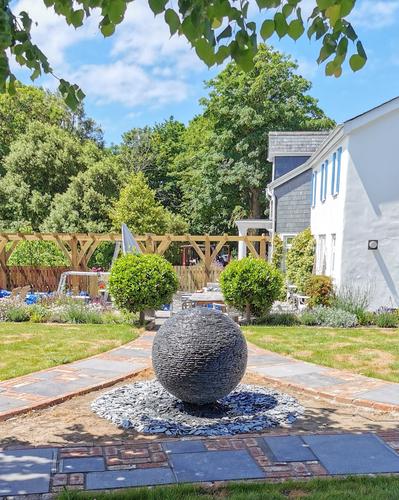 Jeremy Hastings 1m Large grey slate ball water feature, in the middle of a triangular pathway. Rock, Cornwall.