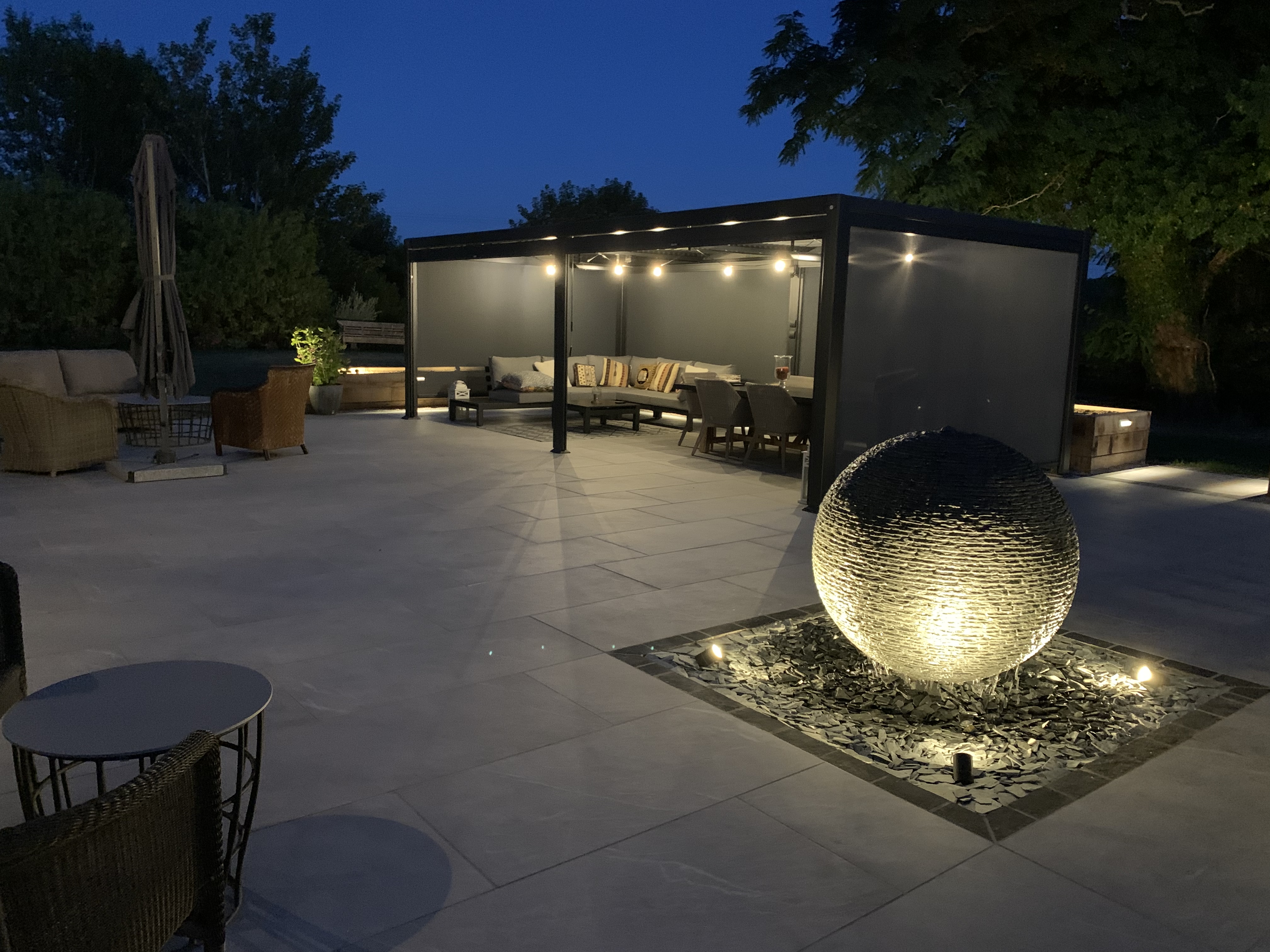 Jeremy Hastings 1m Large grey slate ball water feature, night photo, Worchestershire.