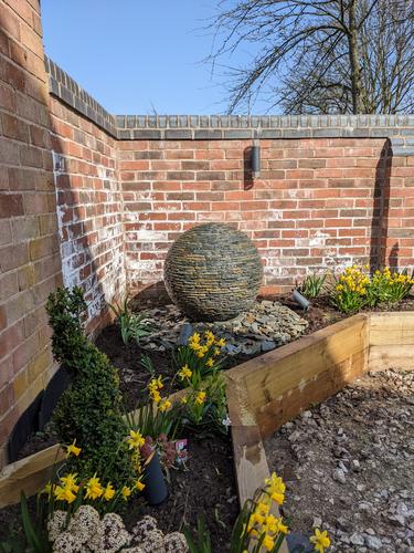 Jeremy Hastings 650mm small rustic slate ball water feature, raised flower bed