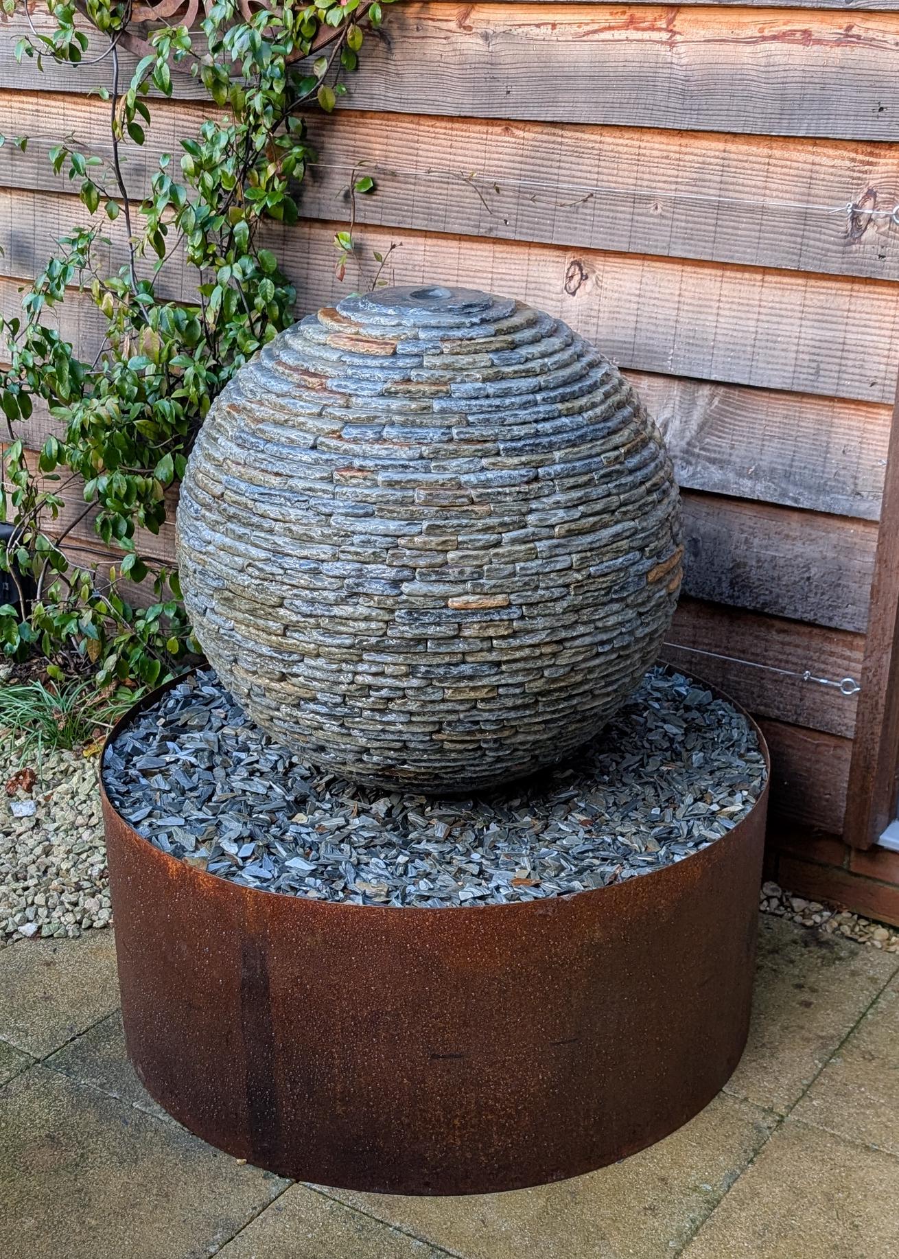 Jeremy Hastings 650mm slate ball water feature, with cremation ashes inside