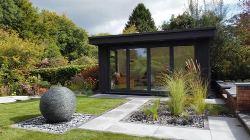 Jeremy Hastings 800mm grey slate ball water feature installed outside a garden office