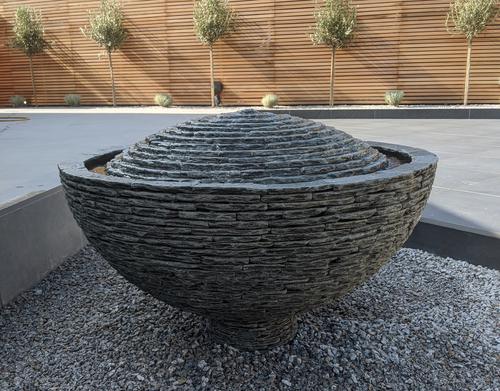 Jeremy Hastings 1m grey slate semi sphere water feature on large patio