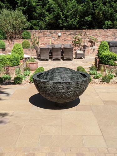 Jeremy Hastings 1.2m grey slate semi sphere water feature on large patio