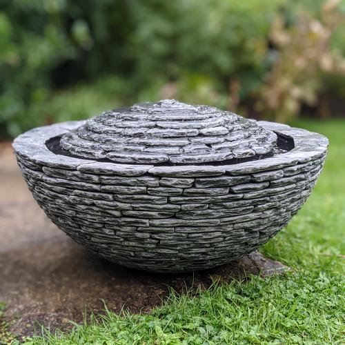 Jeremy Hastings 650mm grey slate semi sphere water feature on large patio