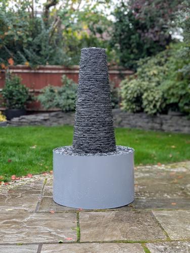 Jeremy Hastings Cornish chimney water feature on a patio with a powder coated steel base