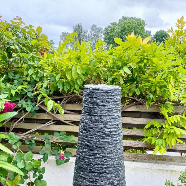 Jeremy Hastings slate Cornish chimney water feature on a small patio in Chiswick