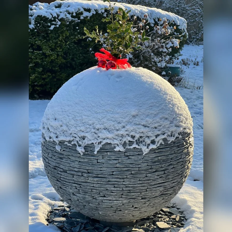 Jeremy Hastings 800mm grey slate ball water feature snow covered, dressed as a christmas pudding sculpture