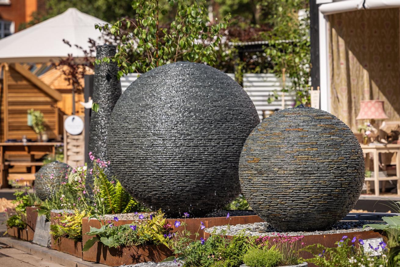 Jeremy Hastings Cornish slate 1.5m Grey Watersphere and 1m Rustic Wtersphere displayed at RHS Chelsea Flower Show 2024